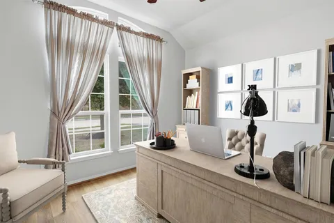 a bedroom with furniture and a window