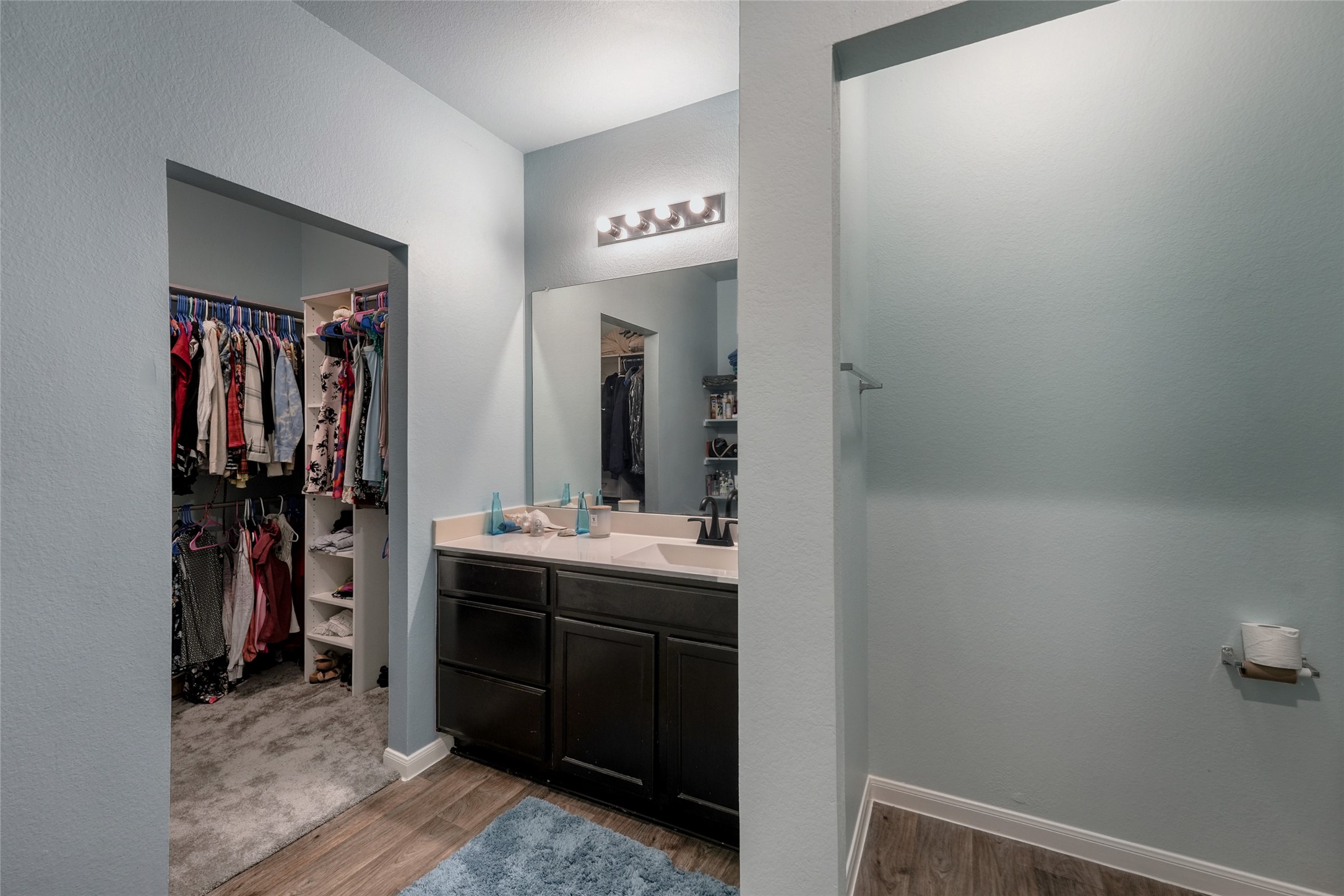 15105 Shell Bark Cove Austin, TX 78724 - Photo 20 of 30 A well-appointed bathroom featuring a vanity with dual sinks and convenient access to an adjacent walk-in closet.
