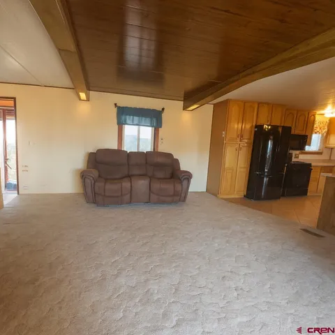 a hallway with couch and a stove