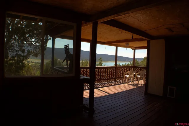 a view of balcony with wooden floor and fence
