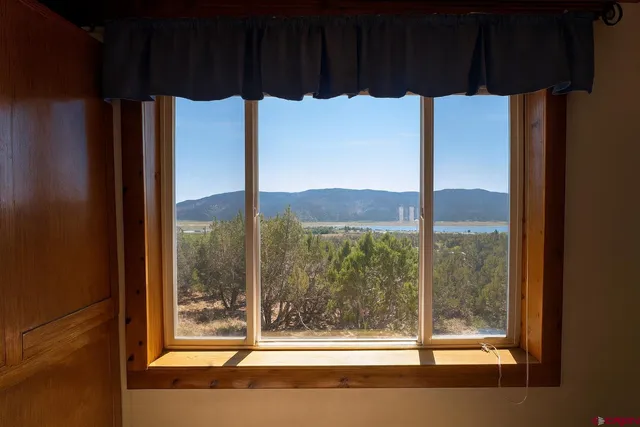 a room that has a large window and a bed