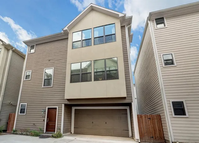 a front view of a house with garage