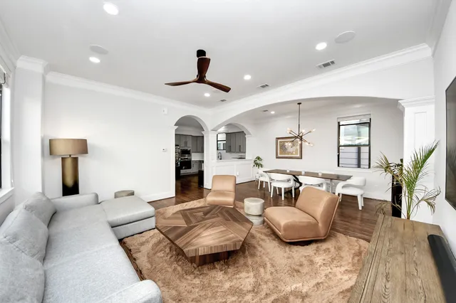 a living room with furniture and wooden floor