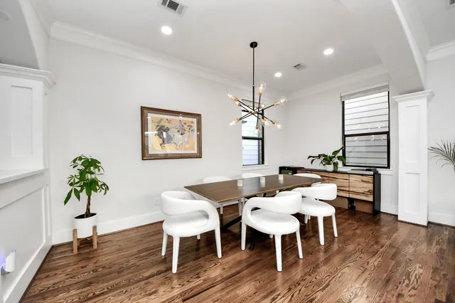 a view of a dining room with furniture wooden floor and chandelier