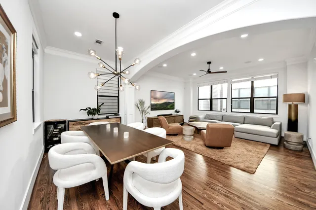 a living room with furniture a rug and a chandelier