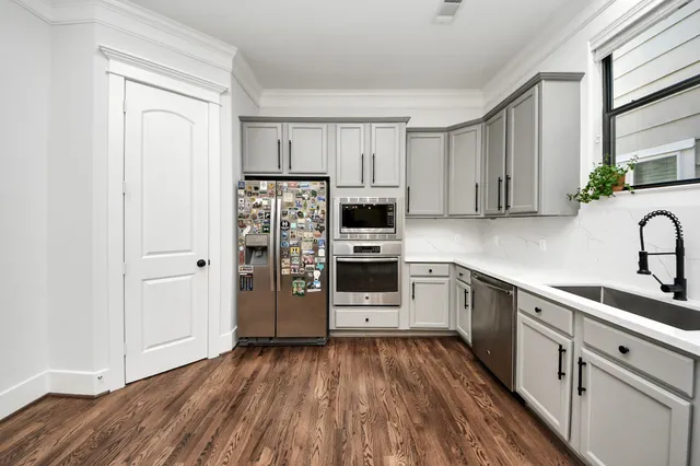 a kitchen with stainless steel appliances a refrigerator and a stove top oven