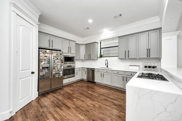 a bathroom with a sink and mirror with bathtub