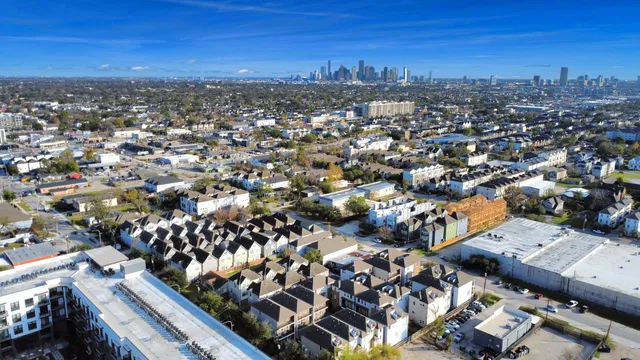 an aerial view of multiple houses with a yard