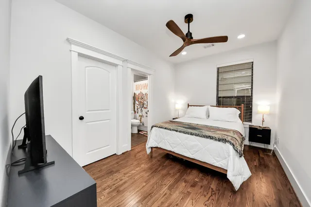 a bedroom with a bed and a flat screen tv