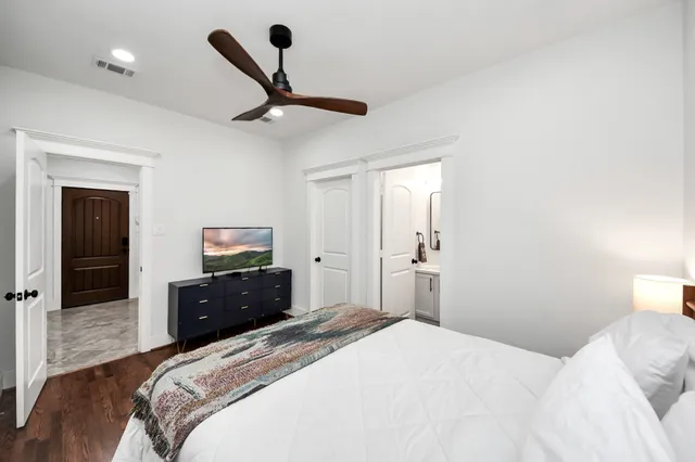 a bedroom with a bed and a dresser