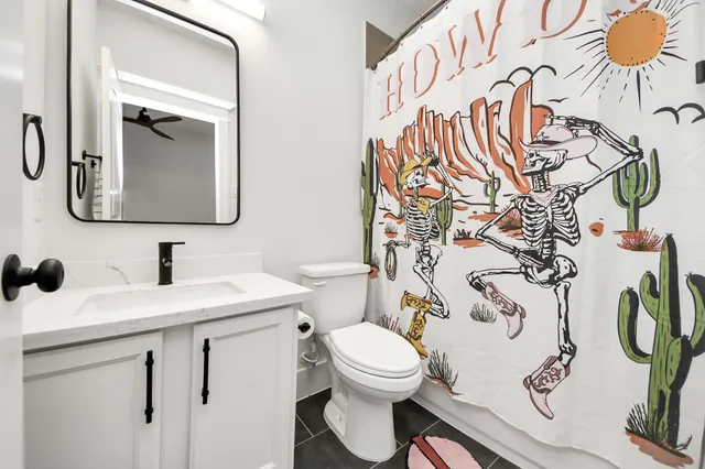 a bathroom with a toilet sink and mirror