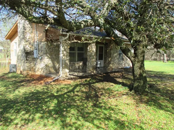 a view of a house with a large tree