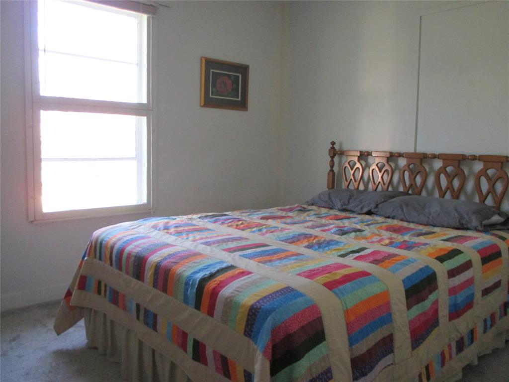306 North Agnew Street Boyd, TX 76023 - Photo 11 of 15 a bedroom with a bed and a window