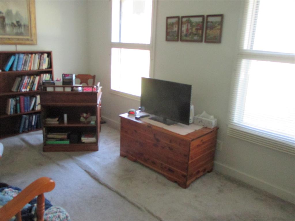 306 North Agnew Street Boyd, TX 76023 - Photo 13 of 15 a living room with furniture and a book shelf