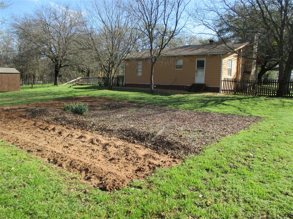 306 North Agnew Street Boyd, TX 76023 - Photo 15 of 15 a view of a house with a yard and large trees