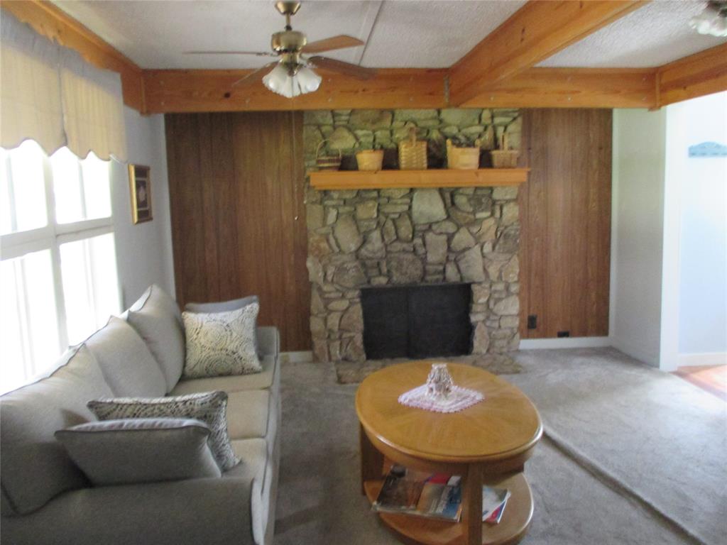 306 North Agnew Street Boyd, TX 76023 - Photo 4 of 15 a living room with furniture a fireplace and a chandelier