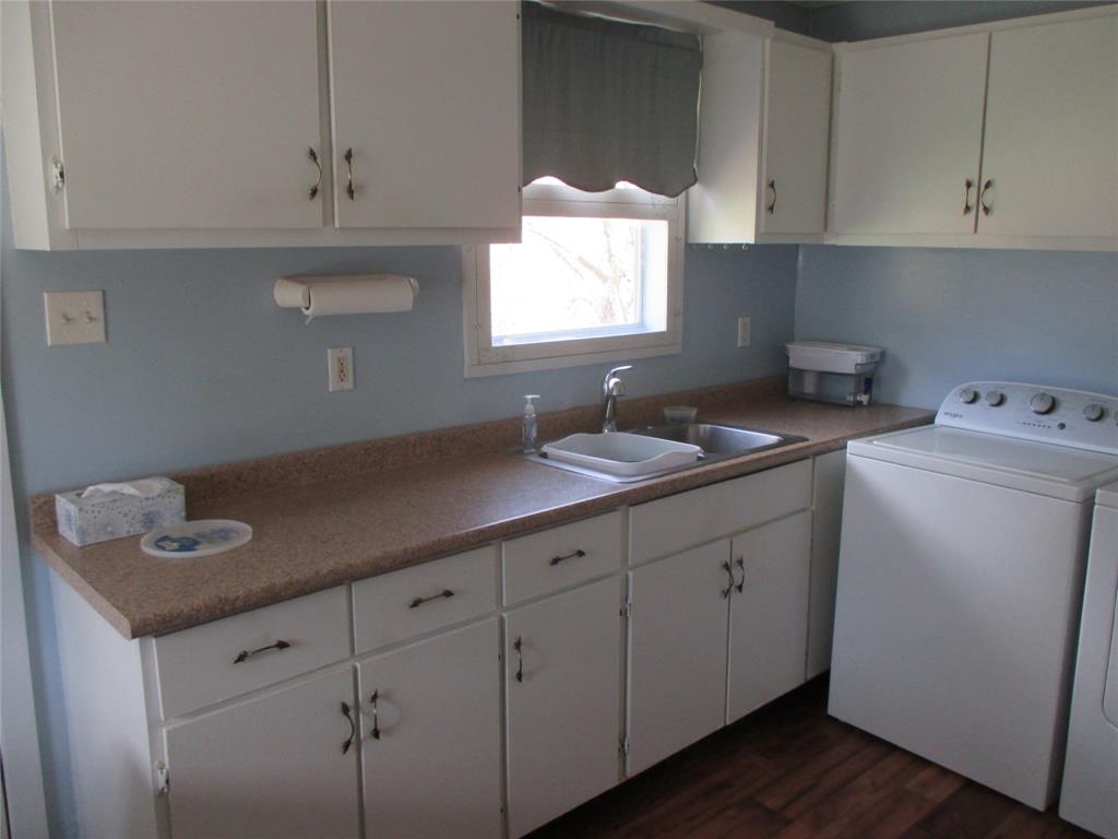 306 North Agnew Street Boyd, TX 76023 - Photo 5 of 15 a kitchen with cabinets appliances and a sink