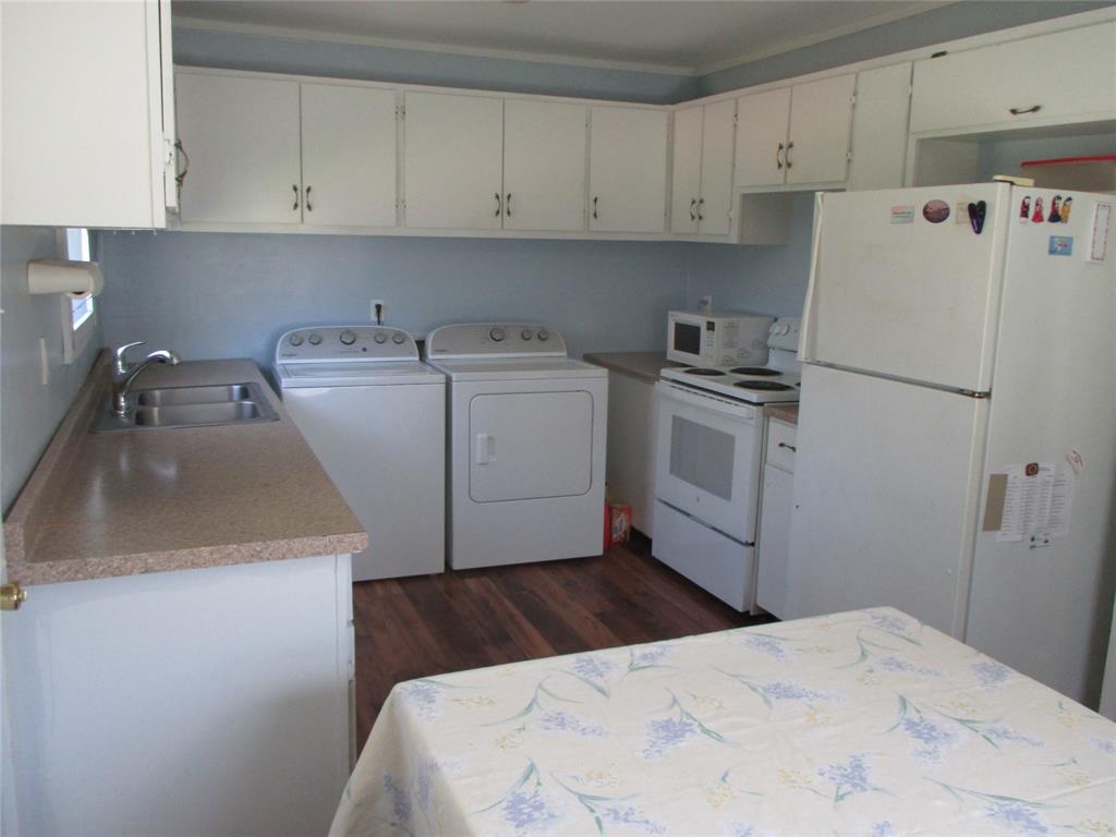 306 North Agnew Street Boyd, TX 76023 - Photo 6 of 15 a kitchen with a refrigerator sink and cabinets