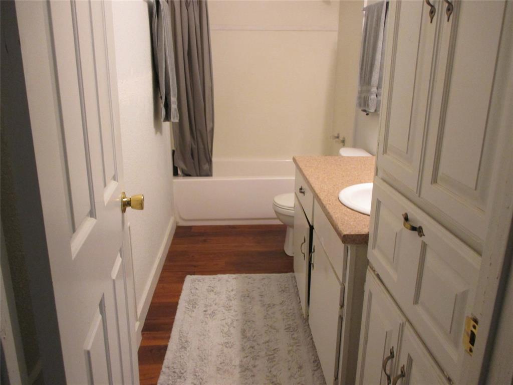 306 North Agnew Street Boyd, TX 76023 - Photo 10 of 15 a view of a hallway with wooden floor and stairs