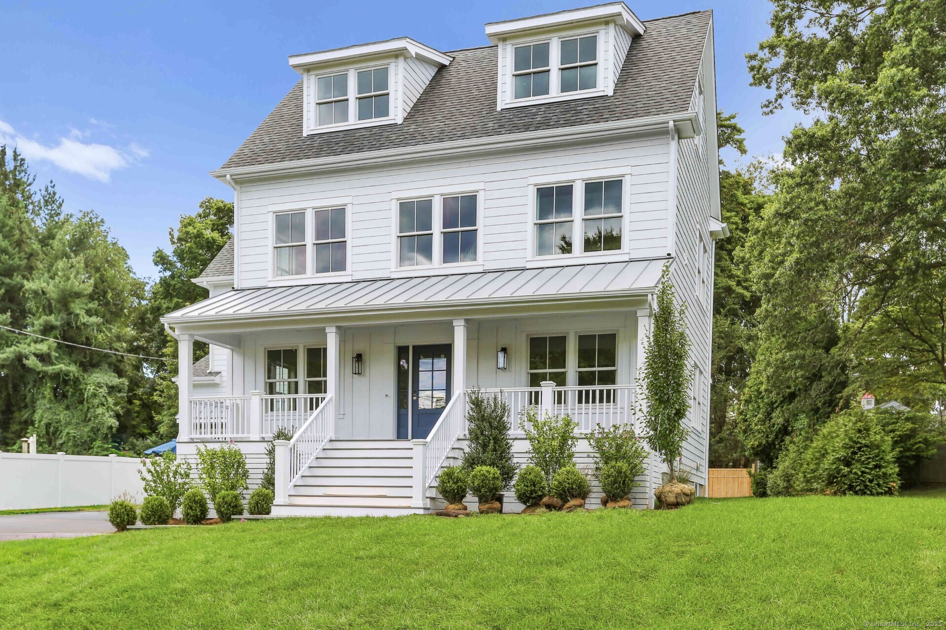 a front view of a house with a garden