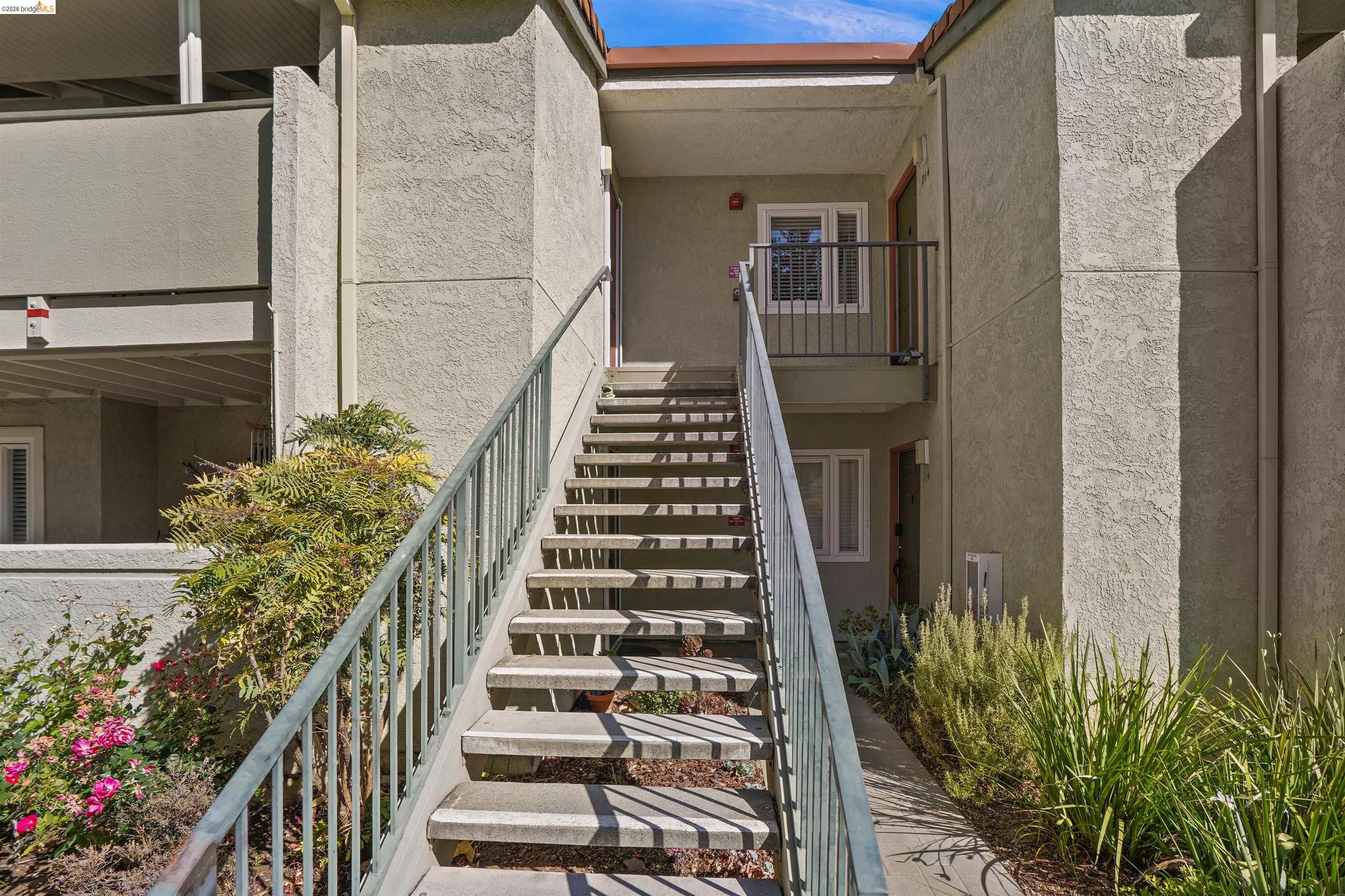 1505 Kirker Pass Road, Unit 214 Concord, CA 94521 - Photo 7 of 55 Exterior staircase with metal railings leading to a second-story entrance