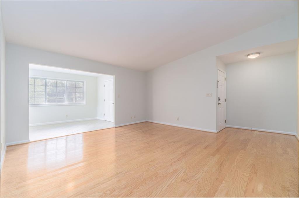 an empty room with a empty space and windows