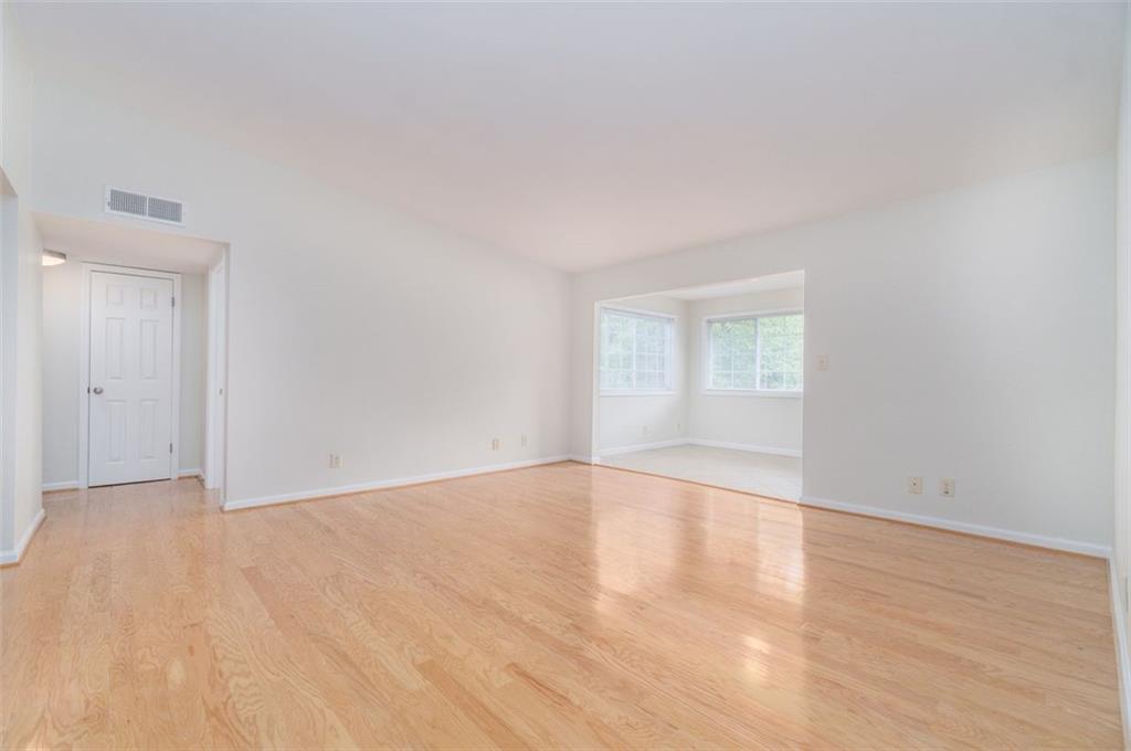 1468 Briarwood Road Northeast, Unit 1304 Brookhaven, GA 30319 - Photo 13 of 17 a view of an empty room with wooden floor and a window