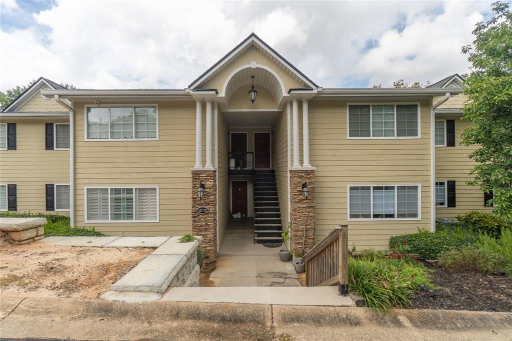 1468 Briarwood Road Northeast, Unit 1304 Brookhaven, GA 30319 - Photo 14 of 17 a front view of a house with a yard and garage