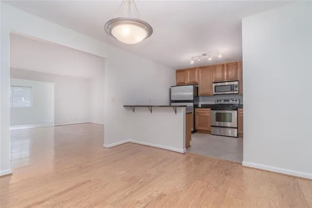 a view of a kitchen with a sink and dishwasher wooden floor
