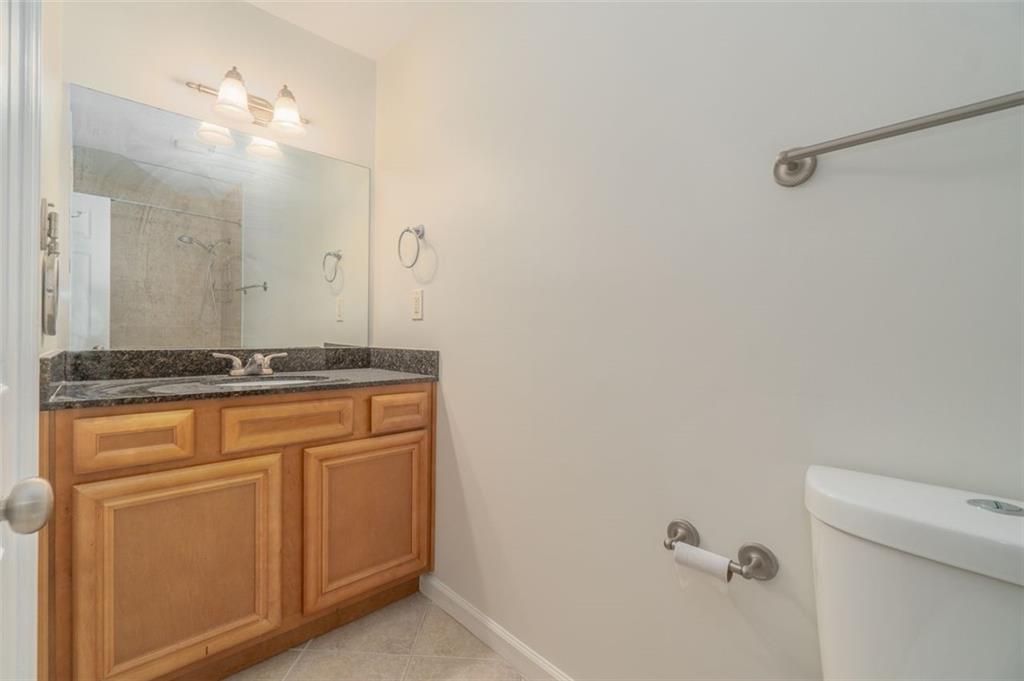 1468 Briarwood Road Northeast, Unit 1304 Brookhaven, GA 30319 - Photo 6 of 17 a bathroom with a granite countertop sink and a mirror