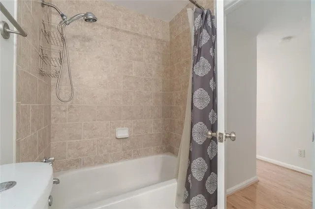 a bathroom with a shower and a bath tub