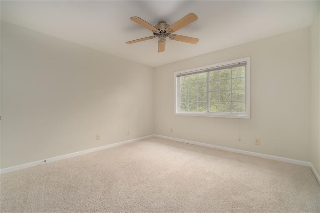 1468 Briarwood Road Northeast, Unit 1304 Brookhaven, GA 30319 - Photo 8 of 17 an empty room with a window and a ceiling fan