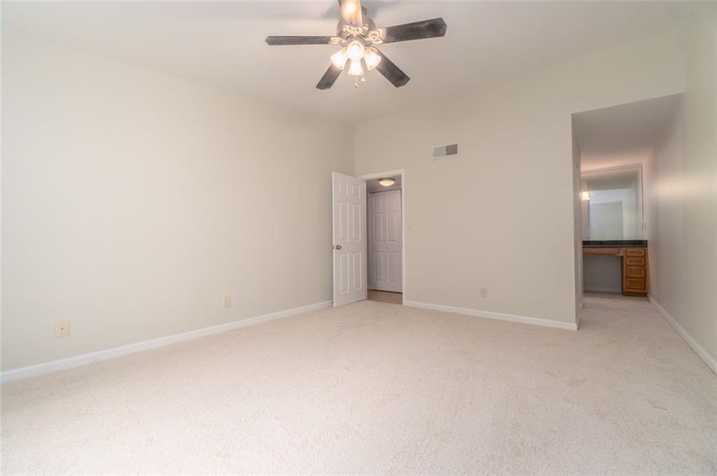 1468 Briarwood Road Northeast, Unit 1304 Brookhaven, GA 30319 - Photo 9 of 17 a view of an empty room and chandelier fan