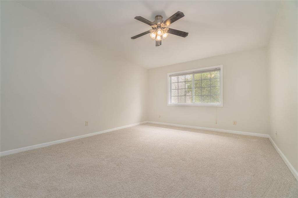1468 Briarwood Road Northeast, Unit 1304 Brookhaven, GA 30319 - Photo 10 of 17 an empty room with a window and a fan