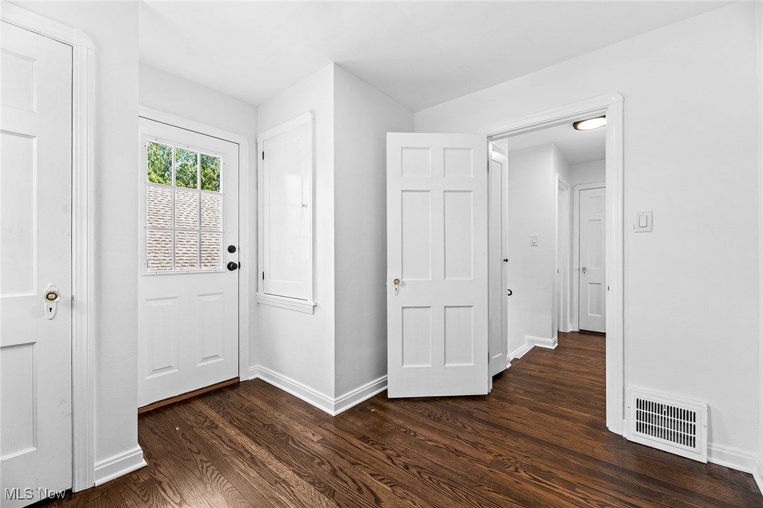 7719 Ackley Road Parma, OH 44129 - Photo 23 of 35 Entryway featuring baseboards and dark wood-style flooring