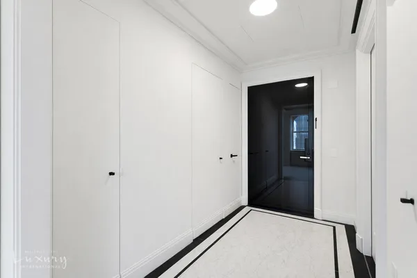 a view of an empty room and wooden floor
