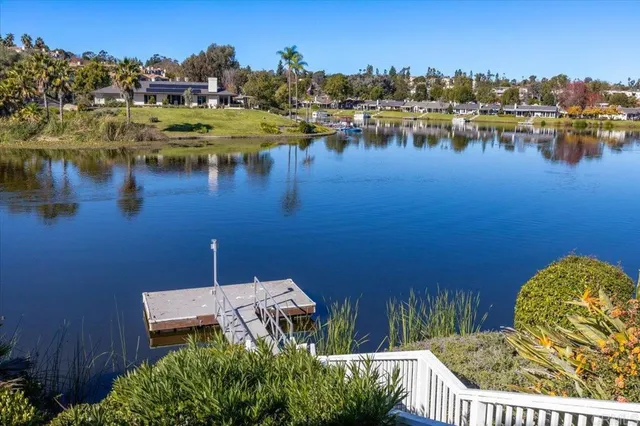 a view of a lake with boats and trees in the background