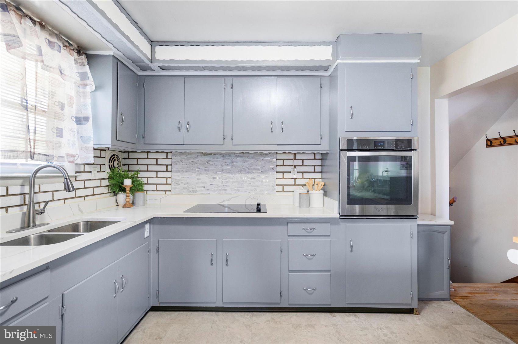 300 Nicholson Road Baltimore, MD 21221 - Photo 12 of 42 a kitchen with white cabinets and sink