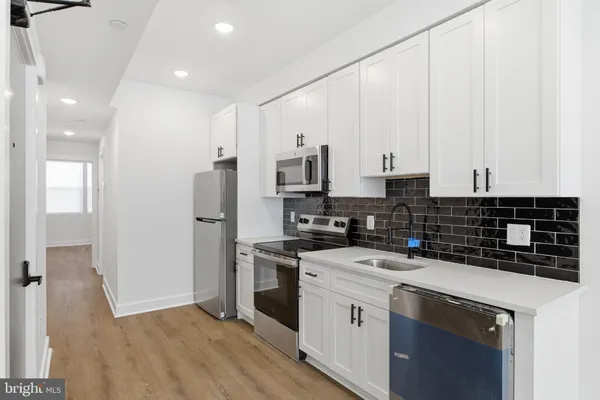 a kitchen with a sink a stove and refrigerator