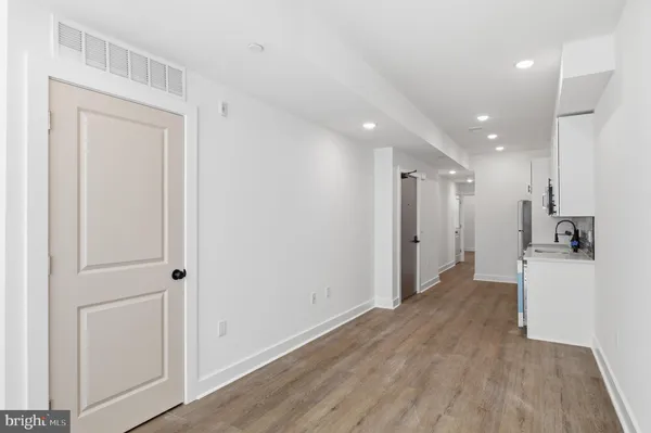 a view of a hallway with wooden floor