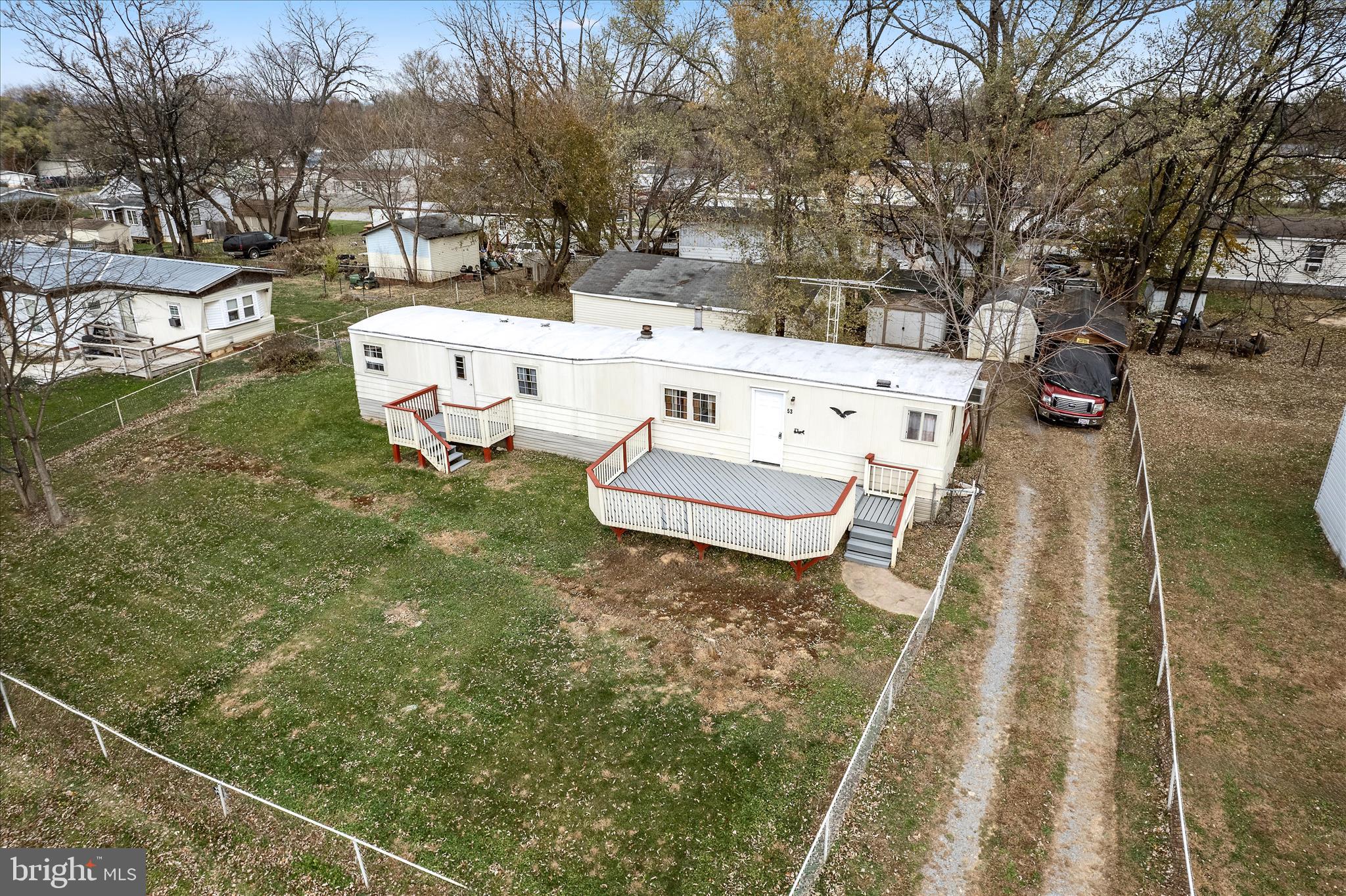 53 Anvil Road Kearneysville, WV 25430 - Photo 40 of 44 a backyard of a house with table and chairs