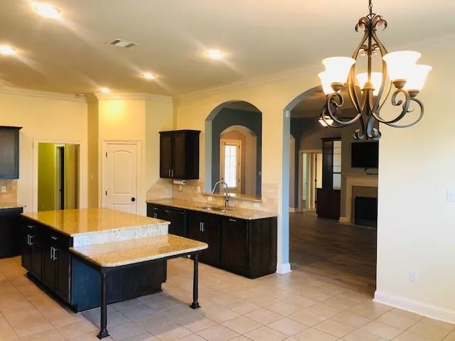 a room with gym equipment and wooden floor