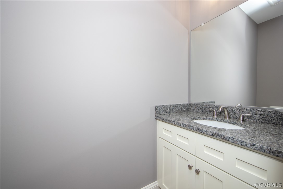 26 Perkins Road Cartersville, VA 23027 - Photo 10 of 22 The half bath offers custom cabinets, granite coun