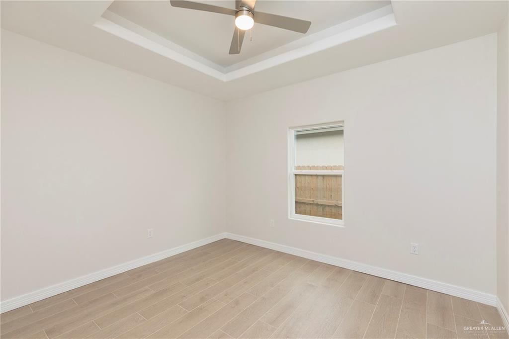 2405 Northgate Lane McAllen, TX 78504 - Photo 11 of 18 an empty room with a window and a fan