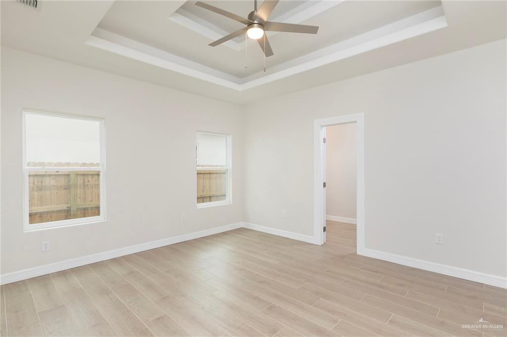 2405 Northgate Lane McAllen, TX 78504 - Photo 8 of 18 an empty room with wooden floor windows and fan