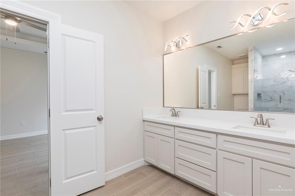 2405 Northgate Lane McAllen, TX 78504 - Photo 9 of 18 a bathroom with a double vanity sink and mirror