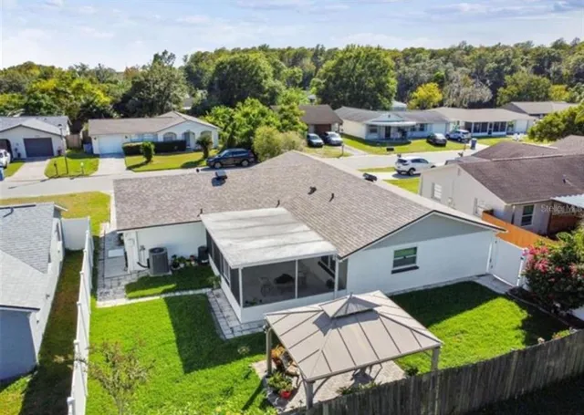 an aerial view of a house with swimming pool garden and patio