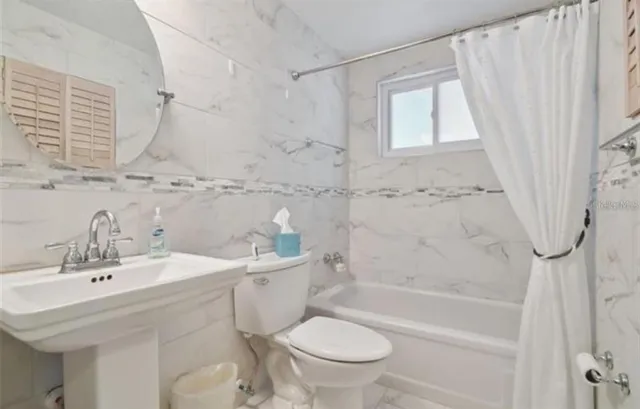 a bathroom with a sink a toilet and a bathtub