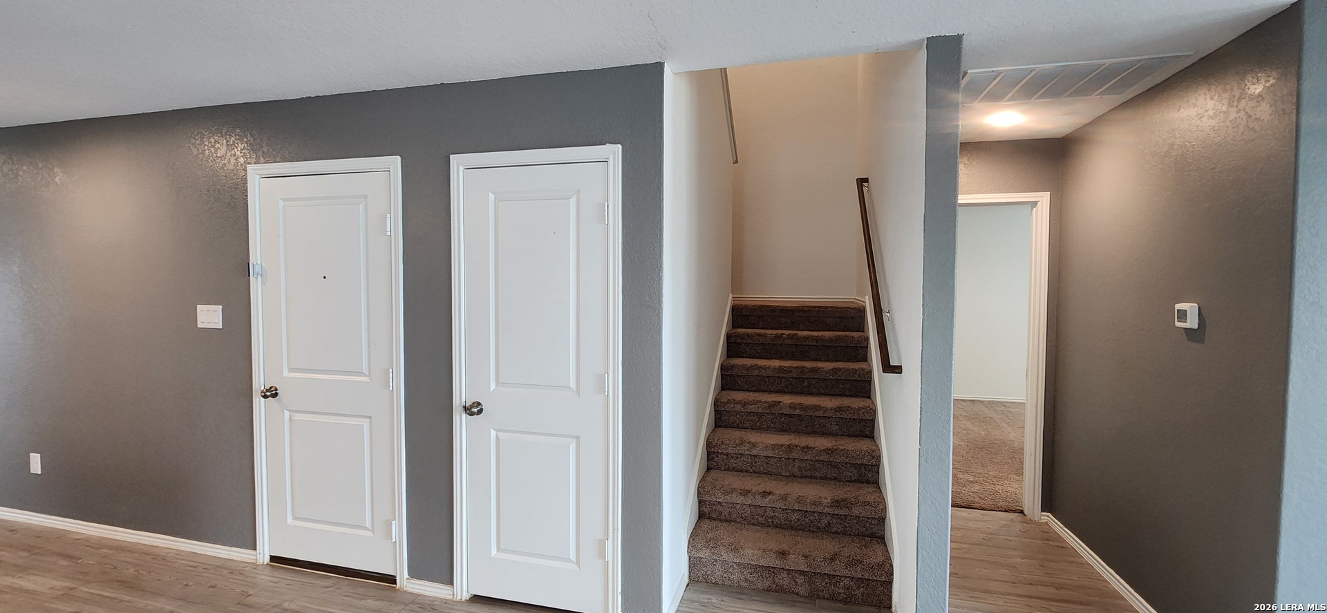 6013 Companion Loop Bulverde, TX 78163 - Photo 17 of 37 a view of a hallway with front door wooden floor and stairs
