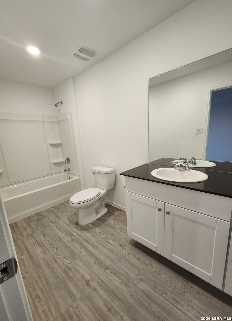 6013 Companion Loop Bulverde, TX 78163 - Photo 27 of 37 a bathroom with a granite countertop sink a toilet and a mirror